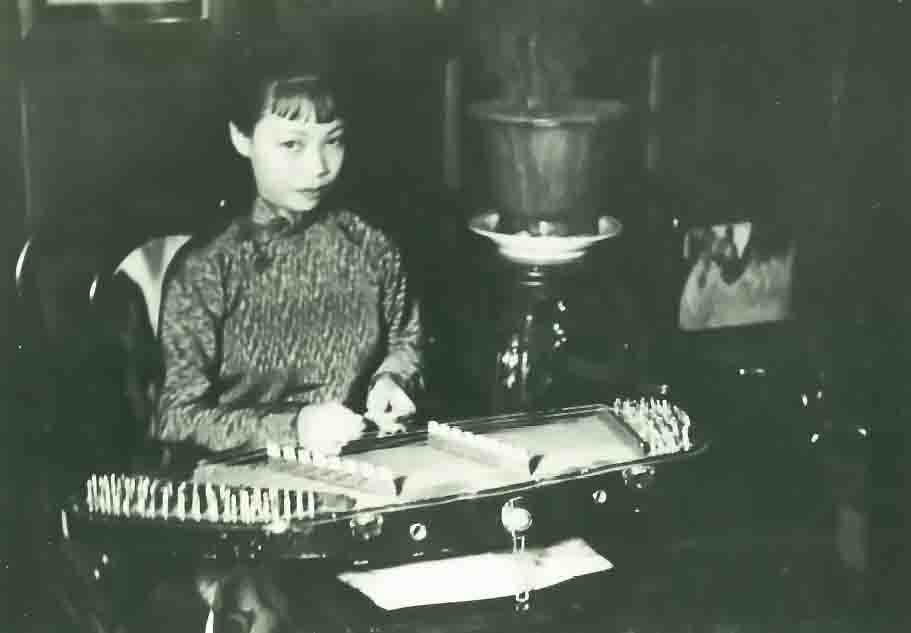 Macao - Girl playing Chinese musical instrument